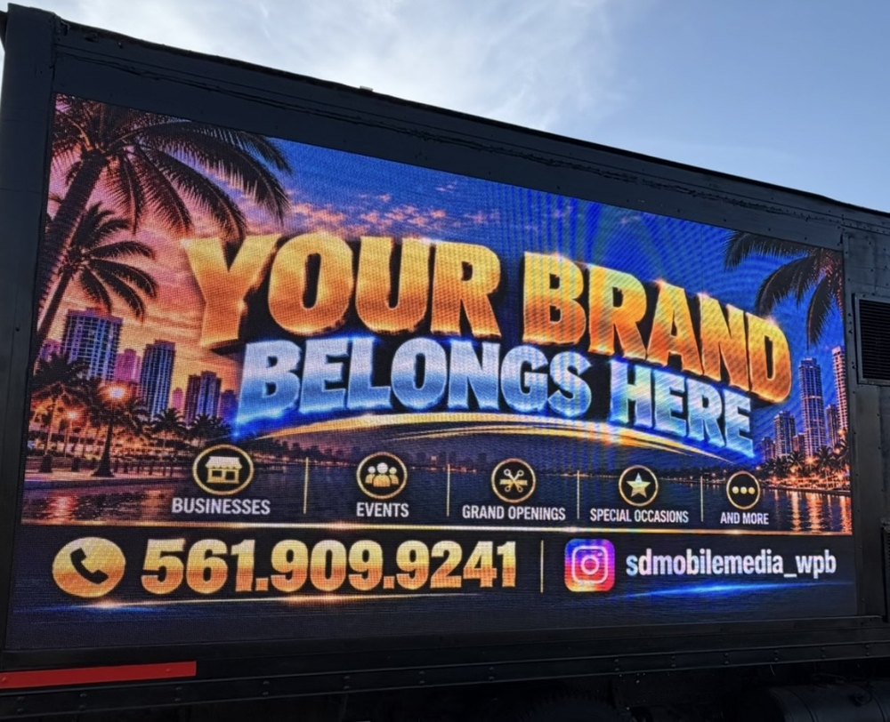 Box truck side LED screen showing a Your Brand Belongs Here ad with the Smart Design phone number and Instagram handle